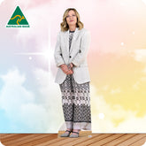 Woman wearing a white blazer and patterned pants on a colorful background with 'Australian Made' logo.